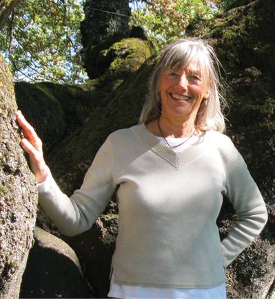 Christy standing beside a mature tree